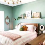 a welcoming bedroom with green walls, wooden furniture, a ledge as .