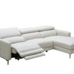 Light grey leather sectional sofa with adjustable back height .